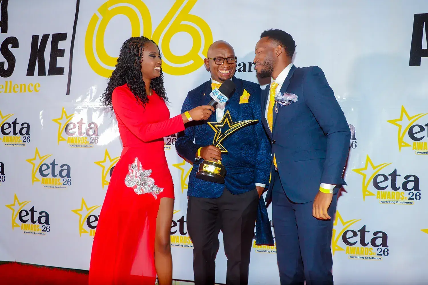 A red carpet interview at the ETA Awards with the trophy